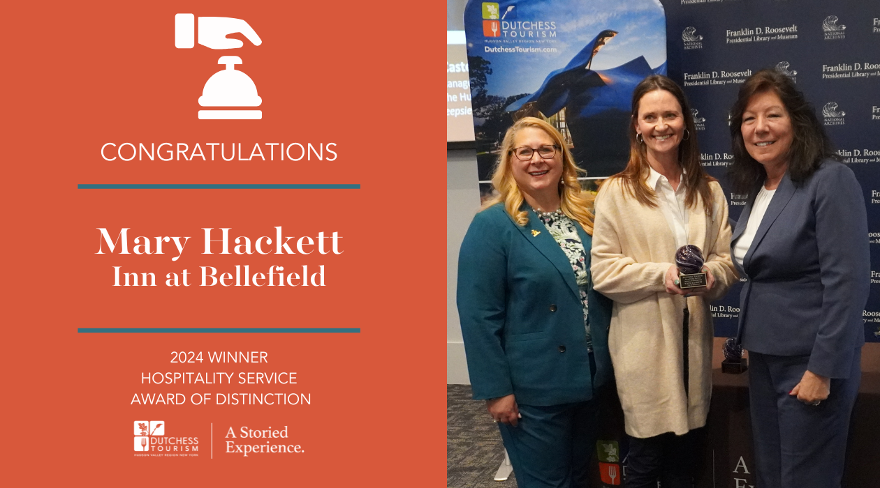 Mary Hackett of the Inn at Bellefield holds her award at the 2024 Awards of Distinction Breakfast alongside Dutchess Tourism CEO Melaine Rottkamp and Dutchess County Executive Sue Serino